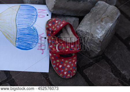 Childrens Shoes And The Flag Of Ukraine, The Warthe War In Ukraine.