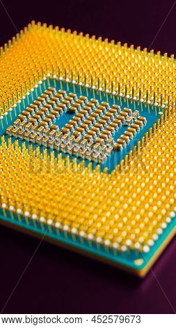 Computer Hardware. Processor Lies On Dark Violet Matte Surface. Cpu And Semiconductors. Vertical Sto
