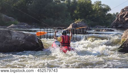 A Man Rowing Inflatable Packraft On Whitewater Of Mountain River. Concept: Summer Extreme Water Spor