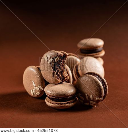 Some Beautiful Brown Macarons Cakes Against A Monochromatic Brown Background.