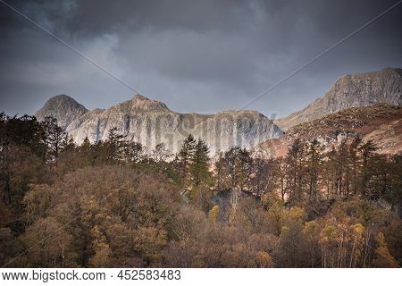 Epic Landscape Image Of Stunning Autumn Sunset Light Across Langdale Pikes Looking From Holme Fell I