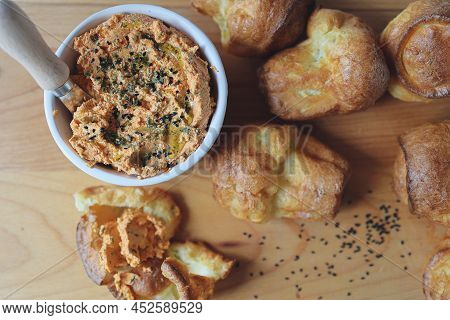 Ricotta Dip With Sun-dried Tomatoes And Baked Paprika In A Ceramic White Bowl And Homemade Popovers,