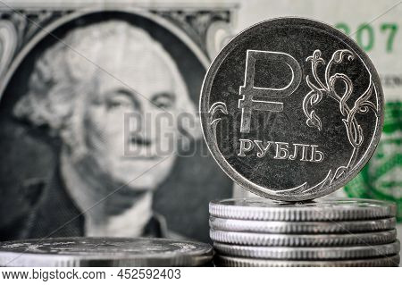 Money Of Usa Vs Russia, Ruble Coin On Background Of One Dollar Bill, Russian Ruble Is Under Sanction