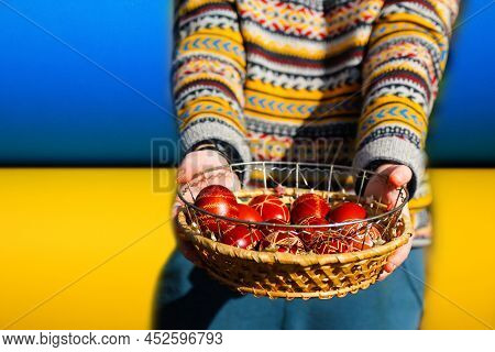 Defocus Ukrainian Young Smiling Woman In Hat Holding Plate Of Collection Of Red Egg On Nature Backgr