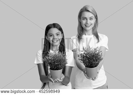 Foster To Adopt. Foster Family. Adopted Daughter And Mother Hold Houseplants. Child Adoption