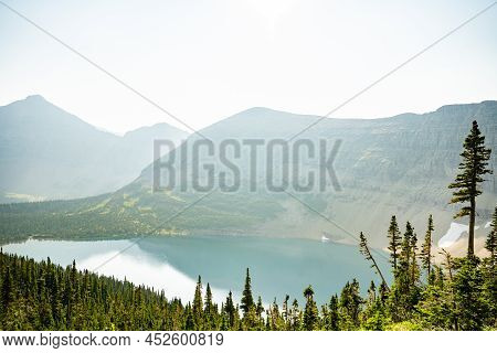 Looking Down On A Hazy Pitamakan Lake On The Way Up To The Pass In Glacier National Park
