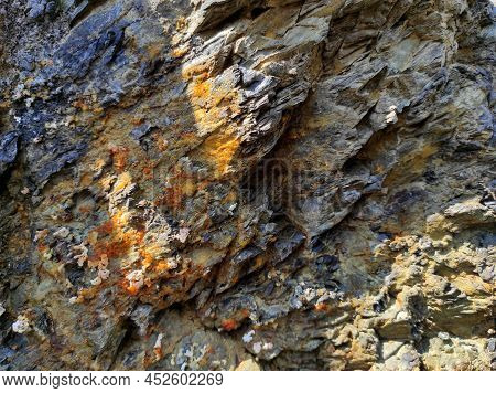 Geodesy. Stone Texture. The Rock Is Brown And Red. Mineral Background. Design From Natural Materials