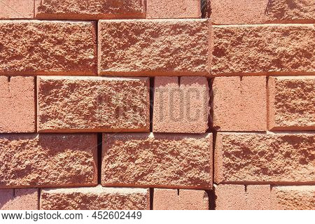Background Of Red Spliter Brick Block With Torn Edge.