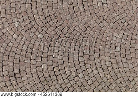 Background Of Basalt Cobble Stone In Red At The Historic Street