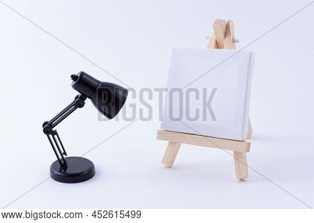 Wooden Easel Miniature With Blank White Square Canvas For Artists And Painters - Mockup. Mini Wooden