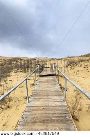 The Staircase Rises To A Sandy Dune. Climbing To The Top In The Desert. Sarykum Dune. Dagestan, Russ