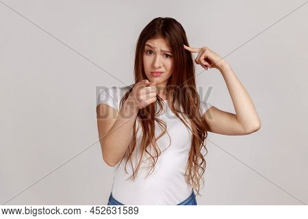 Youre Idiot With Insane Crazy Plan. Displeased Woman Showing Stupid Gesture And Pointing To Camera, 