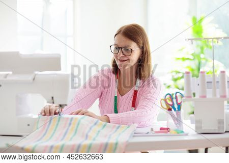 Woman Sewing At White Desk. Fashion Design Workshop. Creative Hobby And Crafts. Handmade Clothes. Ta