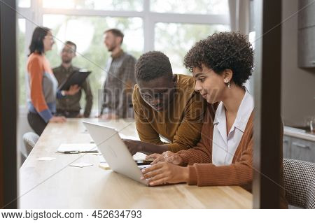 Businessman And A Group Of Employees Discussing Business Documen