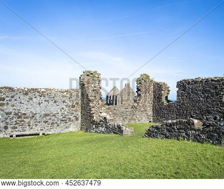 Bushmills, Northern Ireland, March 18, 2022. Dunluce Castle Ruins In A Sunny Day.