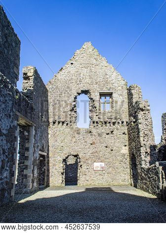 Bushmills, Northern Ireland, March 18, 2022. Dunluce Castle Ruins At Northern Ireland In A Sunny Day