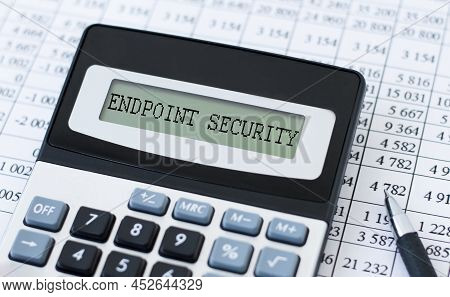Endpoint Security Inscription On The Screen Of The Calculator On The Table Next To The Financial Acc