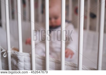 Baby Stay Alone In Crib Frame. Help For Kids, Adoption Concept Photo.