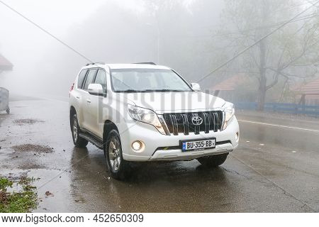 Kvemo Kartli, Georgia - October 8, 2021: White Offroad Car Toyota Land Cruiser Prado 150 In A Heavy 