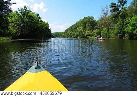 A Paddle For Rowing Yellow While Kayaking On The River With Beautiful Seaweed. And River Landscape