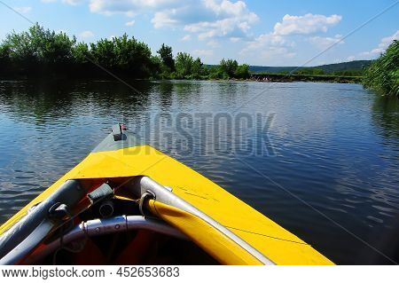 A Paddle For Rowing Yellow While Kayaking On The River With Beautiful Seaweed. And River Landscape