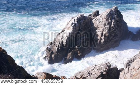 Rocky Craggy Ocean Beach. Big Waves Crashing On Bare Cliff, Blue Water Splashing, Sea Foam. Power Of