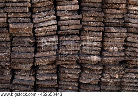 Weathered Shabby Brown Wood Planks In Vertical Piles Backdrop. Rustic Textured Pattern.