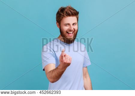 Come Here. Portrait Of Bearded Man Making Beckoning Gesture, Inviting To Come, Flirting And Looking 