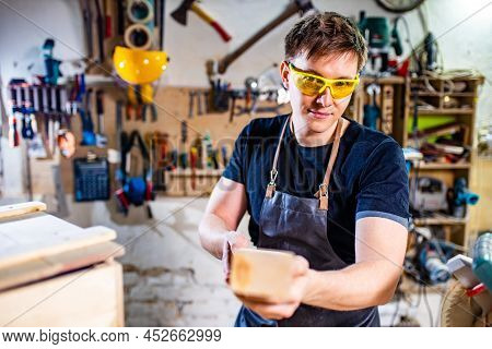 Carpenter Young Working With Wood In Workshop