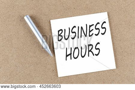 Business Hours Text On A Sticky Note On A Cork Board With Pencil ,