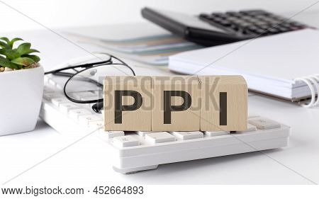 Ppi Written On Wooden Cube On Keyboard With Office Tools