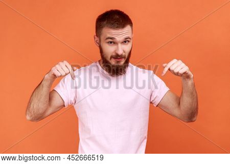 Portrait Of Man Pointing Fingers Down Paying Attention At Advertising Area, Showing Freespace, Looki