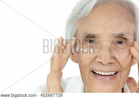 Close-up,face Of Asian Senior Woman Applying Eye Cream,anti-aging,nourishing Under Eye,facial Treatm