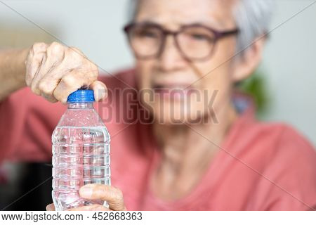 Trouble Opening The Bottle Of Drinking Water In The Elderly Age,life Problem,senior Woman With Numbn