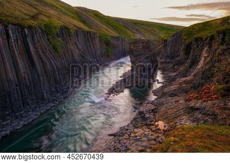 Studlagil Canyon With The Jokulsa A Bru River In East Iceland Photographed At Sunset.