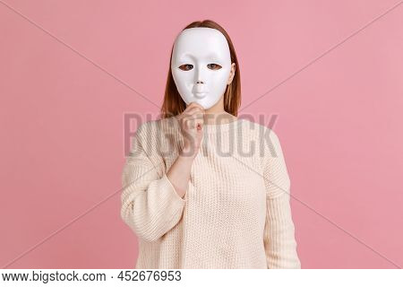 Portrait Of Unknown Anonymous Woman Covering Her Face With White Mask, Hiding Her Real Personality, 