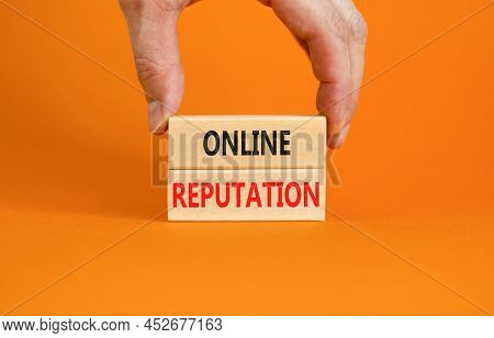 Online Reputation Symbol. Wooden Blocks With Concept Words Online Reputation On Beautiful Orange Bac
