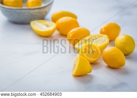 Small citrus fruits limequat with bowl on table