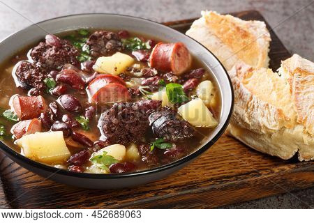 Slow Cooked Portuguese Stone Soup Or Sopa Da Pedra Closeup In The Plate On The Table. Horizontal