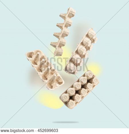 An Egg Carton Made Of Recycled Cardboard On A Blue Background. An Egg Container For Recycling Flies