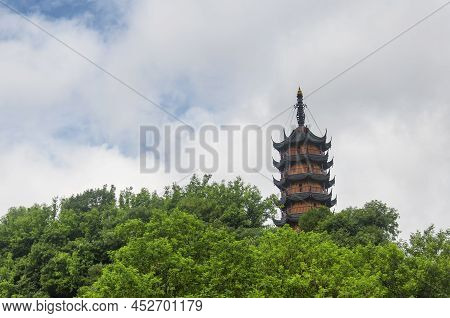 Cishou Pagoda Rising Above The Trees Within The Jinshan Buddhist Temple Scenic Area In Zhenjiang Chi