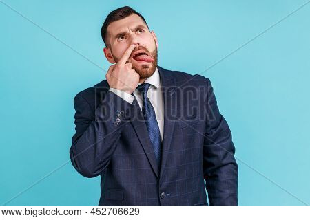 Misconduct, Bad Manners. Funny Man Wearing Official Style Suit Picking Nose And Sticking Out Tongue 