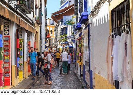 Cordoba, Spain - May 23, 2017: Unidentified Tourists Inspect The Houses And Streets Of The Medieval 
