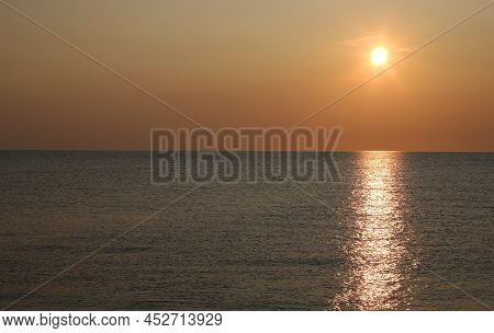 Sun Over The Water Of The Sea And Orange Sky