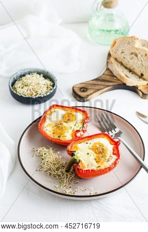 Bell Pepper Halves Baked With Egg And Microgreens On A Plate On The Table. Flexitarian Organic Diet.