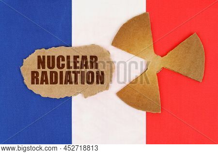 The Concept Of Industry And Radiation. On The Flag Of France, The Symbol Of Radioactivity And Torn C