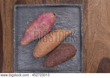 Colorful Root Vegetables Pink, Purple And Orange Organic Sweet Potatos