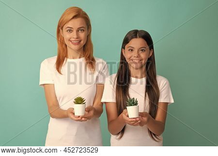 Happy Adoptive Family Of Adopted Daughter Child And Woman Mother Smile Holding Houseplants, Adoption