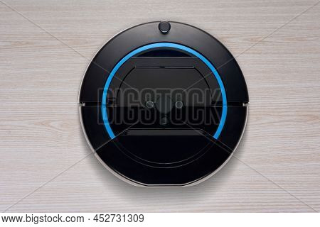 Top View Of Robotic Vacuum Cleaner On The Wooden Floor