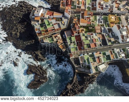 Aerial Top View On Colorful Houses And Black Lava Rocks In Small Village Punta Brava Near Puerto De